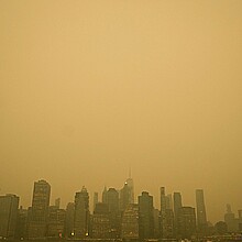 An orange haze settles over Manhattan amid haze and smoke coming to NYC from Canada