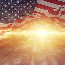 Sun shining through American flag