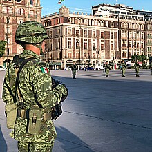 Mexican soldier stands for the raising of the national flag in the Zócalo square in Mexico City