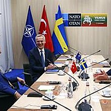 NATO Secretary-General Jens Stoltenberg (C), Turkish President Tayyip Erdogan (L) and Swedish Prime Minister Ulf Kristersson (R) react during a meeting, on the eve of a NATO summit, in Vilnius, Lithuania, 10 July 2023