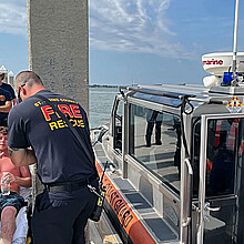 Charles Gregory receives care from EMS after being rescued a dozen miles off Florida's coast on Saturday