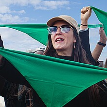 Hispanic women with green scarves on reproductive rights and safe end pegnancy protest in Latin America