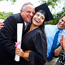 Hispanic student and family celebrating graduation