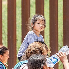 A group of migrants enter Arizona from Mexico in July 2023 through a hole in the border fence near Sasabe, Arizona. The group turned themselves in to a waiting CBP agent.