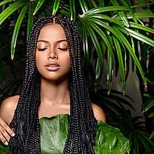 Young girl with dreadlocks in tropical environment