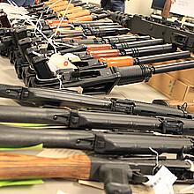 Guns, handguns, AK-47s and .50 caliber rifles, on display during an announcement about arrests and weapons seizures made during Operation Fast and Furious