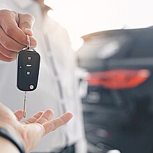 Una mano recibiendo una llaves por la compra de un auto