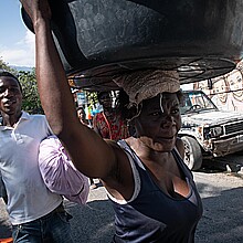 Residents walk down a street this Saturday in Port-au-Prince (Haiti). Suspected criminals were killed by the Haitian National Police during an attack on the National Palace on Friday night in Port-au-Prince, orchestrated by the "Vivre Ensemble" coalition of armed gangs